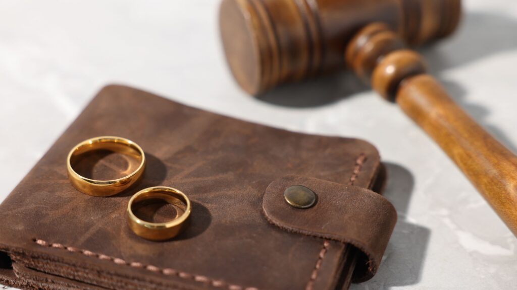 Wedding rings, a gavel, and a wallet illustrating legal and financial factors in how long does alimony last