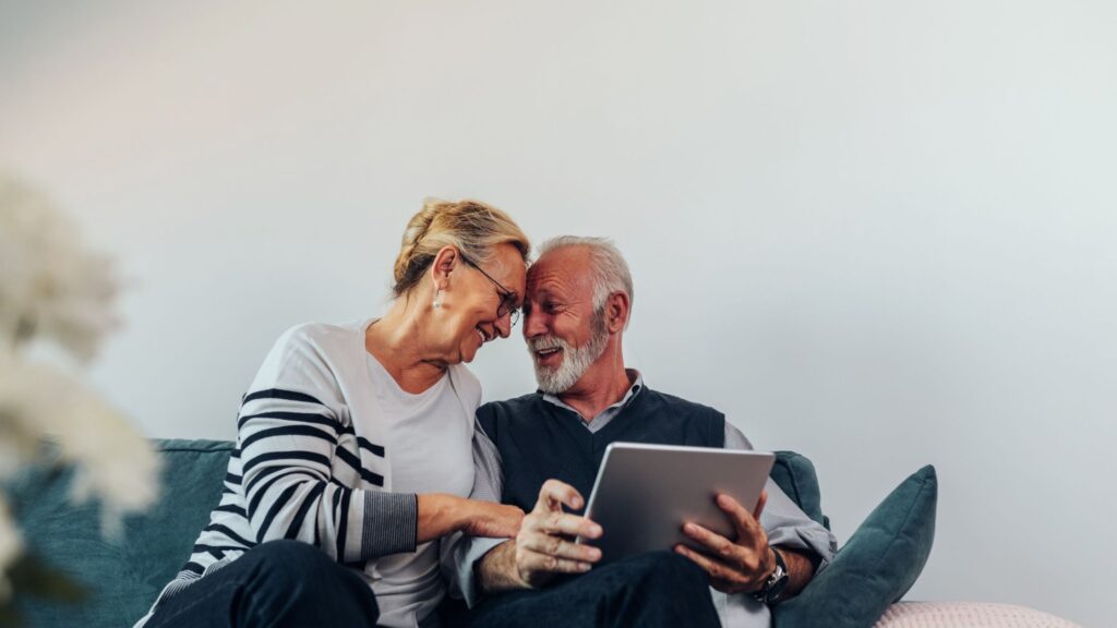 Retired couple reviewing financial information together at home.