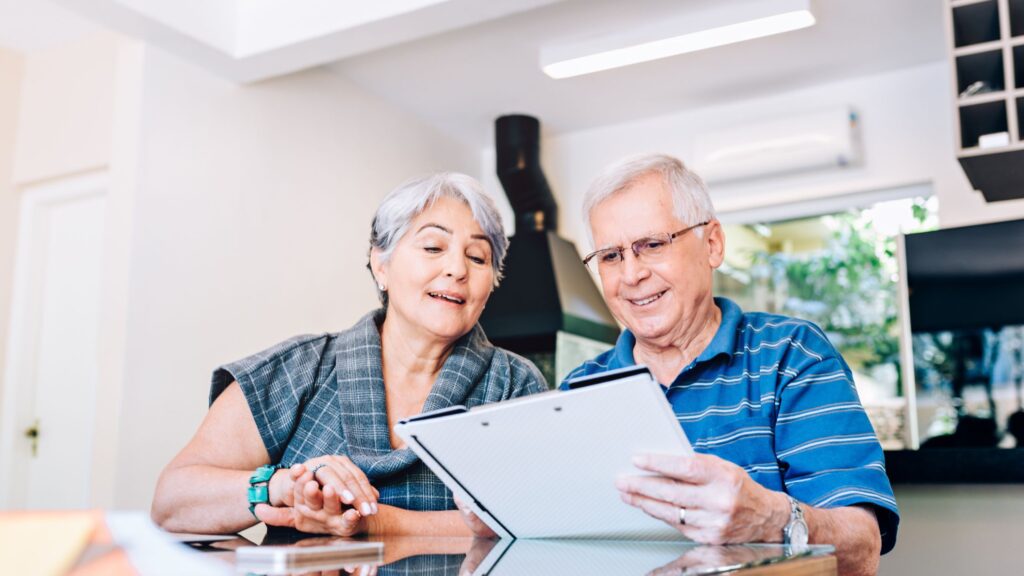 Couple reviewing retirement documents and financial paperwork.