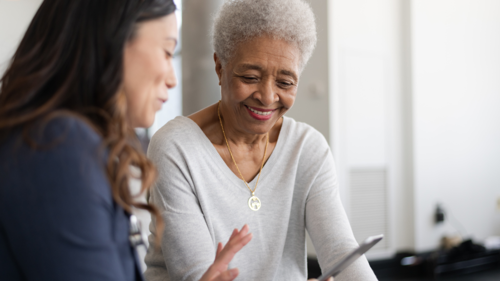 Senior woman reviewing financial documents with a professional advisor as part of aging parents planning