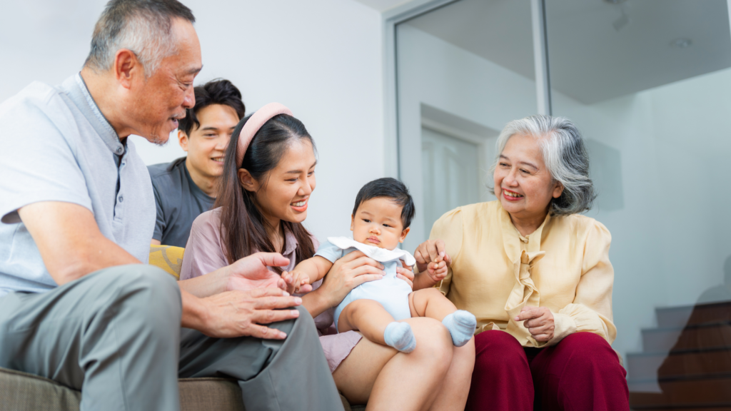 Multigenerational family with grandparents, adult children, and baby representing family coordination in elder care planning
