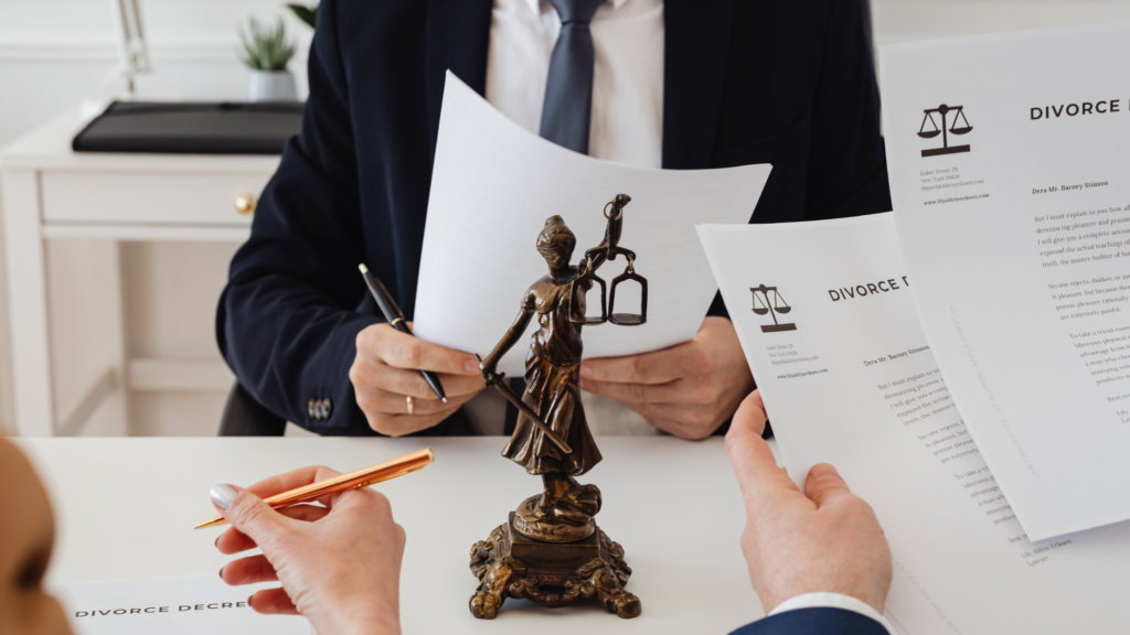 Two people reviewing and pointing at a divorce decree document during a settlement meeting